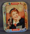 pulls a drink from her can of licenced brand product Soda